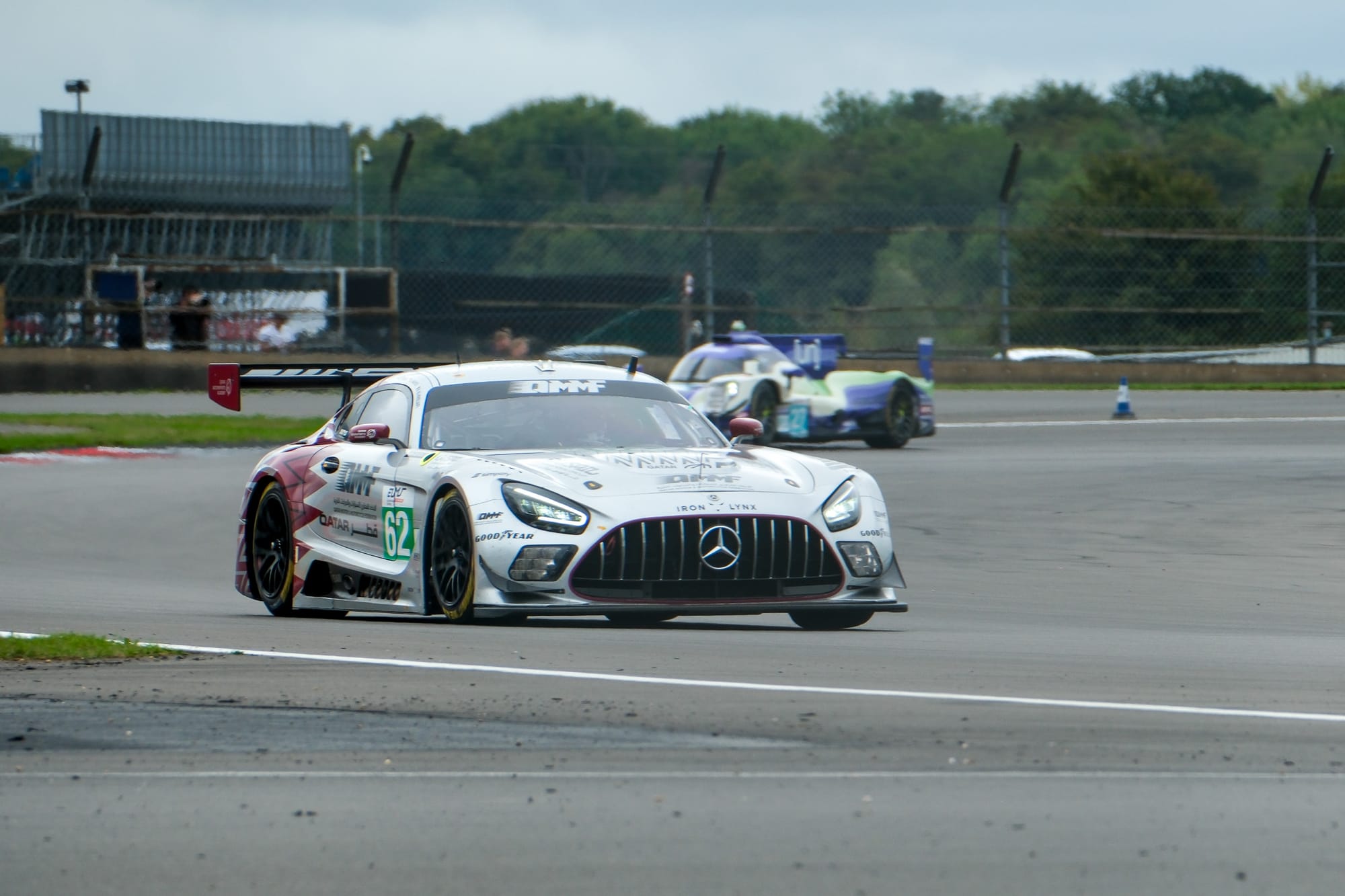 The #62 Team Qatar by Iron Lynx Mercedes-AMG GT3 with a prototype behind it at Silverstone, early in the 4 Hours of Silverstone